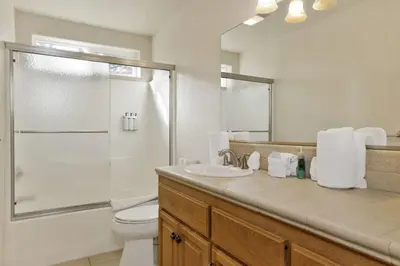 a bathroom with a toilet and a shower and a sink at Brownie Retreat Walk-to-Summit Mountain Getaway for Snowboarders & Skiers in Big Bear Lake