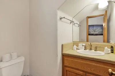 a bathroom with a sink and a mirror at Brownie Resort Retreat Walk-to-Ski Snow Summit Duplex Getaway in Big Bear Lake