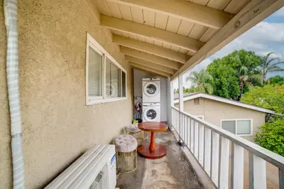 a balcony with a washing machine and a table at Work and Play! Studio 7 Mi to Dtwn San Bernardino in Rialto