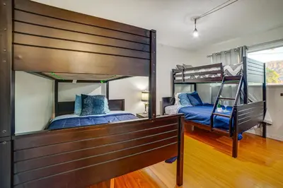 two beds in a room with two bunk beds at Home 1 Mi to UC Riverside Families Welcome! in Riverside