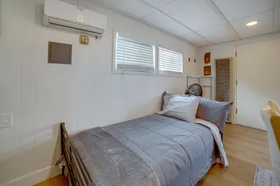 a bedroom with a bed in the corner of a room at 5 Mi to Dtwn Riverside and Hospital! Remote-Work Hub in Riverside