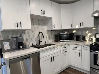 a kitchen with white cabinets and a sink at Cozy Home near Beaches, LAX, SoFi, Intuit Dome,405 in Hawthorne