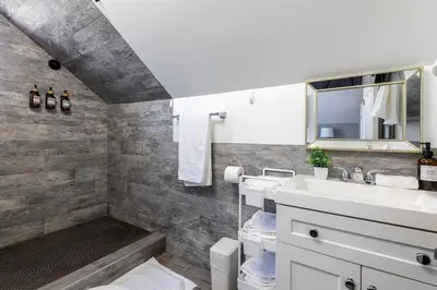 a bathroom with a sink and a mirror at Hawthorne Haven Spacious 4BR Retreat in Hawthorne