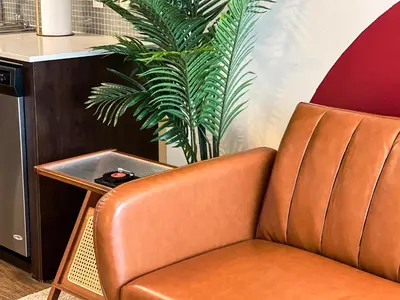 a brown leather chair sitting next to a table at BOHO Style Home LA -Free Parking 10min To Cedars in Los Angeles