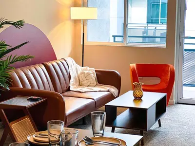 a living room with a couch and a chair at BOHO Style Home LA -Free Parking 10min To Cedars in Los Angeles