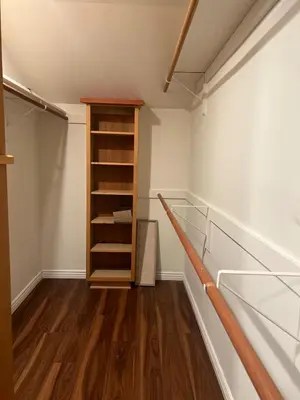 an empty room with a closet with wooden shelves at Cozy Home in Picturesque LA Near Major Attractions