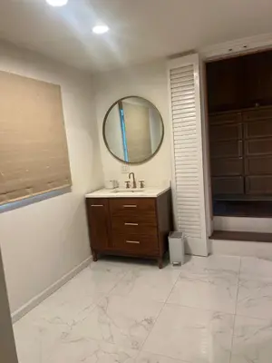 a bathroom with a sink and a mirror at Cozy Home in Picturesque LA Near Major Attractions