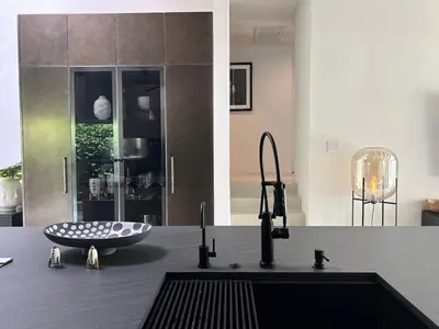 a kitchen with a counter top with a sink at Hillside Luxury MidCentury Modern Spa Retreat View in Los Angeles