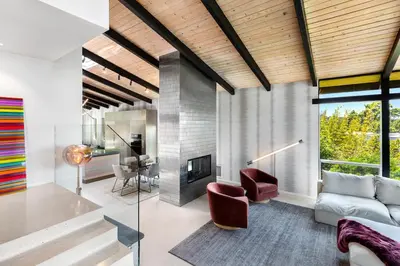 a living room with a couch and a fireplace at Hillside Luxury MidCentury Modern Spa Retreat View in Los Angeles