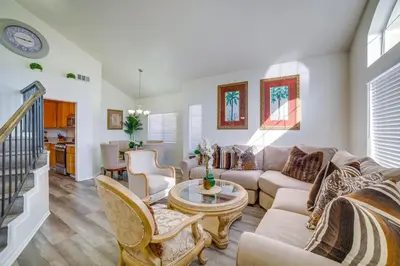 a living room with a couch and a table at Family Home with Hot Tub! 2 Mi to Dtwn Riverside in Riverside