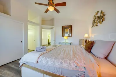 a bedroom with a bed with a ceiling fan at Family Home with Hot Tub! 2 Mi to Dtwn Riverside in Riverside