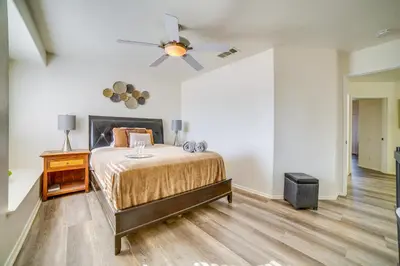 a bedroom with a bed and a ceiling fan at Family Home with Hot Tub! 2 Mi to Dtwn Riverside in Riverside