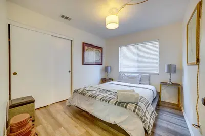 a bedroom with a bed and a large window at Family Home with Hot Tub! 2 Mi to Dtwn Riverside in Riverside