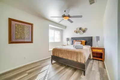 a bedroom with a bed and a ceiling fan at Family Home with Hot Tub! 2 Mi to Dtwn Riverside in Riverside