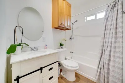 a bathroom with a sink and a toilet and a mirror at Work and Play! Studio Retreat 2 Mi to Dtwn Riverside in Riverside