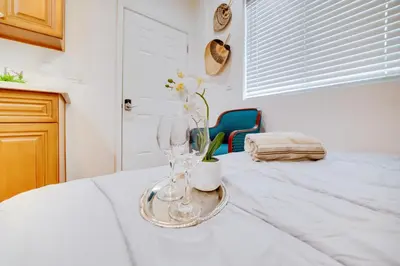 a table with two wine glasses on top of it at Work and Play! Studio Retreat 2 Mi to Dtwn Riverside in Riverside