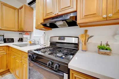 a kitchen with a stove and a sink at Work and Play! Studio Retreat 2 Mi to Dtwn Riverside in Riverside
