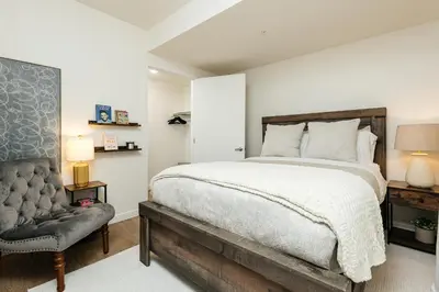 a bedroom with a large bed and a chair at Beautiful 1BR with City Views in Los Angeles