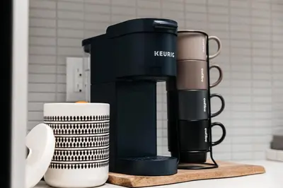 a black coffee maker sitting on a counter next to a cup at Beautiful 1BR with City Views in Los Angeles