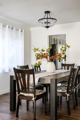 a dining room table with chairs and a vase with flowers at Cozy Full Suites Bright & Private Great Value in Norwalk