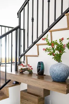a staircase with a blue vase and flowers on a wooden bench at Cozy Full Suite Private Bathroom Quiet Stay in Norwalk