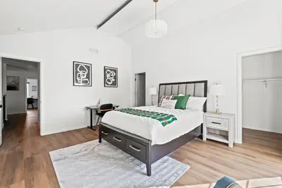 a white bedroom with a large bed and a rug at Upgraded Queen Suite Private Ensuite Bright Stay in Norwalk