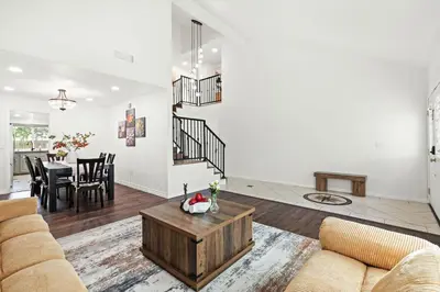 a living room with a couch and a table at Upgraded Queen Suite Private Ensuite Bright Stay in Norwalk