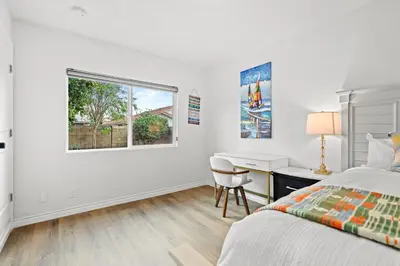 a bedroom with a bed and a desk and a window at Premium Queen Room Private Ensuite Bright in Norwalk