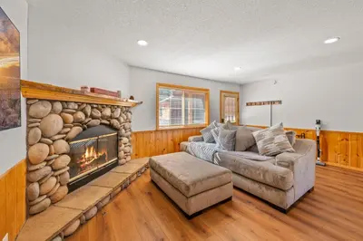 a living room with a couch and a fireplace at Log Cabin Dream - Log Cabin, Walk to Lake, Fireplace, Deck, BBQ in Big Bear Lake