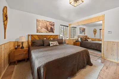a bedroom with a large bed and a mirror at The Hideaway - Near Lake & Village, Hot Tub, Fireplace, AC in Big Bear Lake