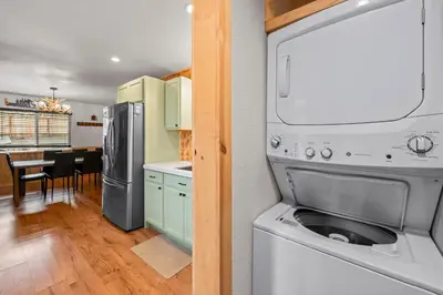 a kitchen and dining room with a washer and dryer at The Hideaway - Near Lake & Village, Hot Tub, Fireplace, AC in Big Bear Lake