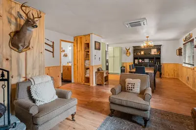 a living room with two chairs and a deer head on the wall at The Hideaway - Near Lake & Village, Hot Tub, Fireplace, AC in Big Bear Lake