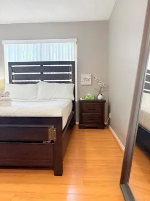 a bedroom with a bed with a large window at Proper Stays at Melrose - West Hollywood Modern 3-Bedroom Designer Home in Los Angeles