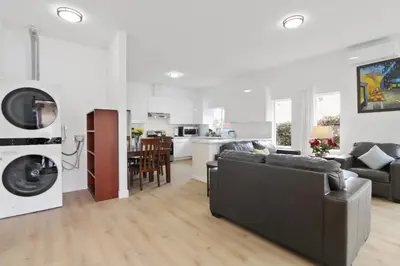a living room with a couch and a kitchen at New Family House Fanstic View Azusa in Azusa