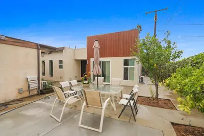 a patio with a table with chairs and an umbrella at New Family House Fanstic View Azusa in Azusa