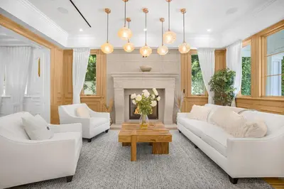 a living room with white furniture and a fireplace at Spaulding Ave Farmhouse in Los Angeles