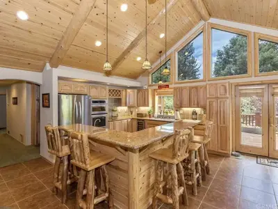a kitchen with a large island with wooden counter tops at Winter Park Cabin Hot Tub And Game Room in Big Bear Lake