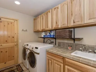 a kitchen with a washing machine and a sink at Winter Park Cabin Hot Tub And Game Room in Big Bear Lake