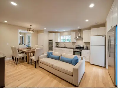 a kitchen and living room with a couch and a table at Modern 4 & 5 BR Townhomes Minutes from Downtown LA in Los Angeles