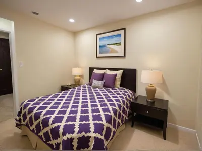 a bedroom with a purple and white bed with two lamps at Modern 4 & 5 BR Townhomes Minutes from Downtown LA in Los Angeles