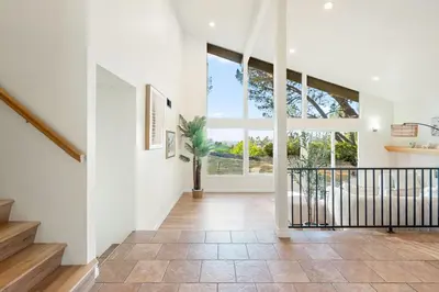 a hallway with a staircase and a large window at Spacious Retreat with Scenic Mountain Views in Santa Ana