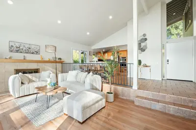 a living room with white furniture and a fireplace at Spacious Retreat with Scenic Mountain Views in Santa Ana
