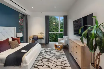 a bedroom with a large bed and a large window at Alta Royale in Los Angeles
