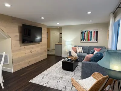 a living room with a couch and a flat screen tv at Private getaway in Studio City Hills universal in Los Angeles