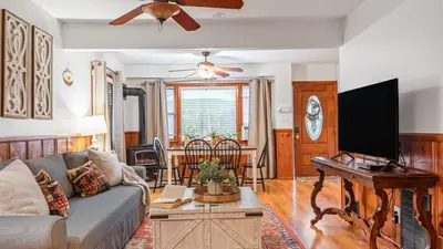 a living room with a couch and a flat screen tv at Minutes to Lake Arrowhead Village Cozy Secluded Cedar Cove by AvantStay in Lake Arrowhead