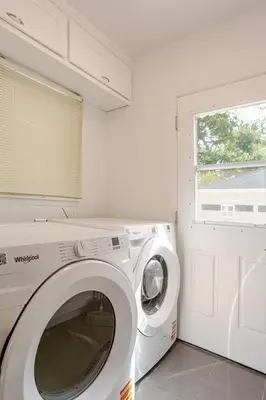 a white washing machine in a room with a window at Relaxing time in Pasadena in Pasadena