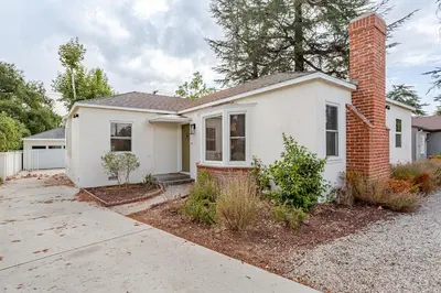a white house with a brick chimney at Relaxing time in Pasadena in Pasadena