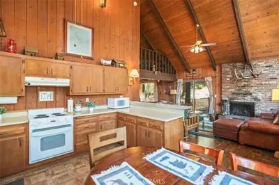 a kitchen with a table and a couch in a room at Mountain Getaway - Stunning Views in Pine Mountain Club