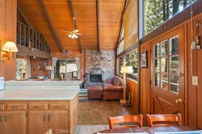 a kitchen and living room of a house with a fireplace at Mountain Getaway - Stunning Views in Pine Mountain Club