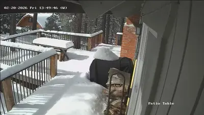 a porch covered in snow next to a fence at Mountain Getaway - Stunning Views in Pine Mountain Club